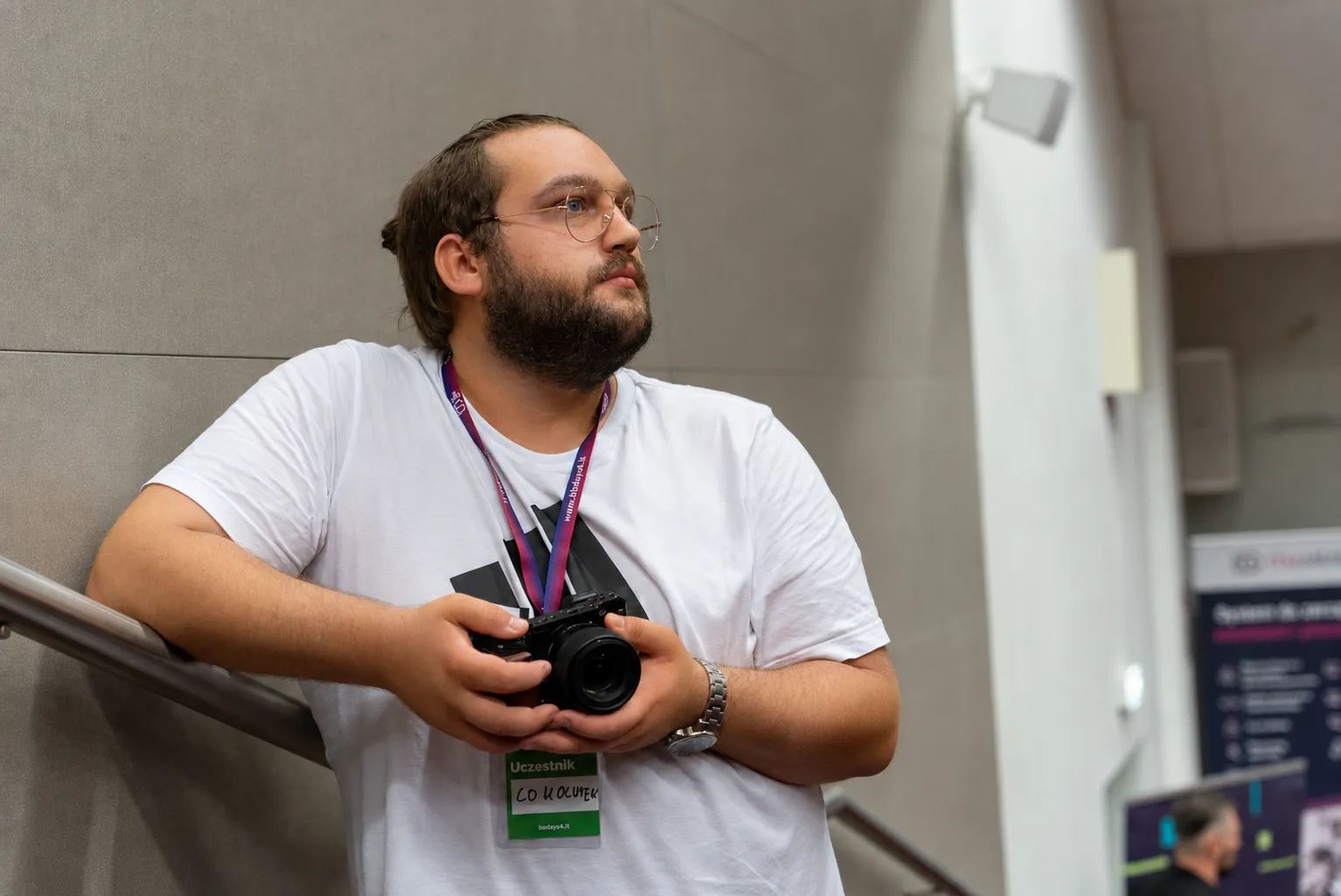 Igor holding a camera at a conference